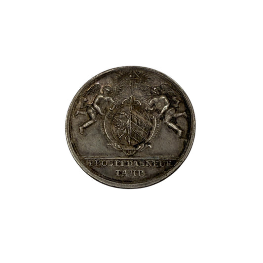 Old coin with a central emblem and text on a white background