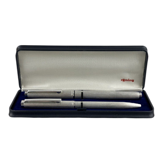 A silver and gold Rotring ballpoint pen set within its original box, which is open displaying the pens and the brand's name on the interior lid.